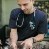 A compassionate veterinarian treats a koala at a clinic in Australia, showcasing animal welfare efforts.